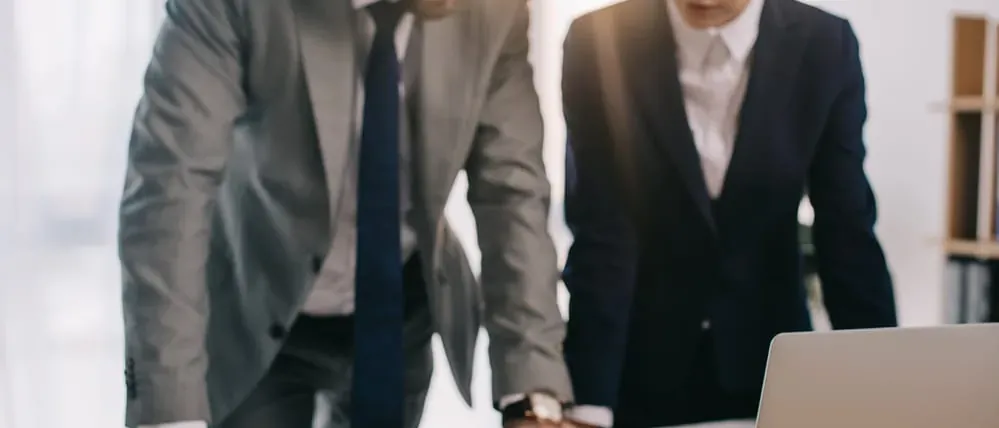 Two attorneys reviewing hernia mesh claims at a desk