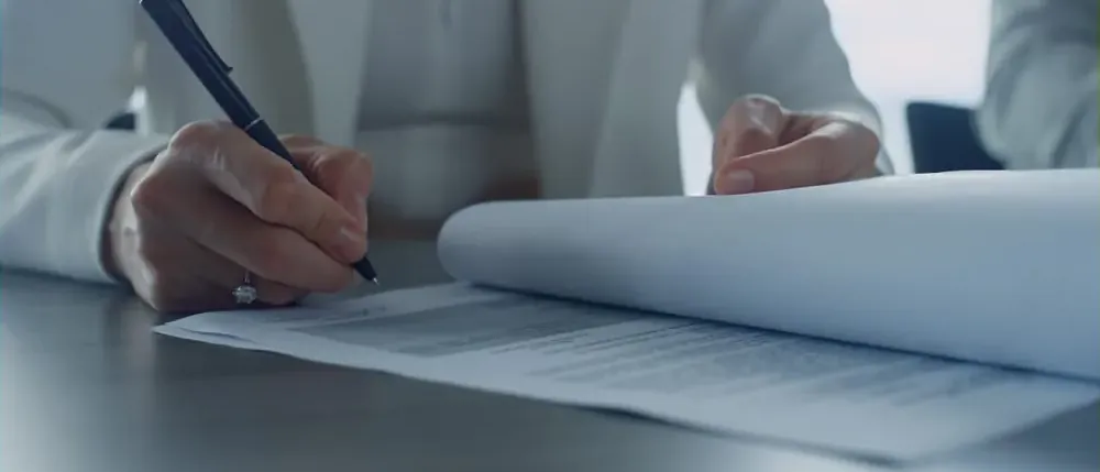 Person signing hernia mesh settlement papers