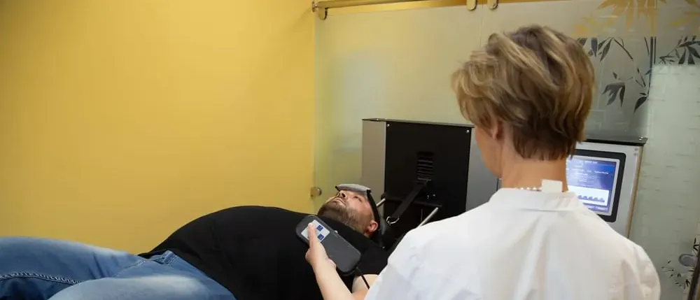 Man lying on an exam table during a medical test for hernia mesh complications